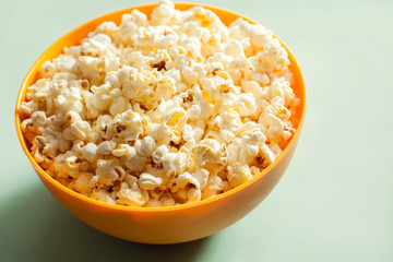 An orange bowl with popcorn isolated