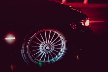A car burnout at a drag racing track. Car tire Night on the way. Car tires in automobile . luxury car wheel close-up . fuel efficient car tires on black background.