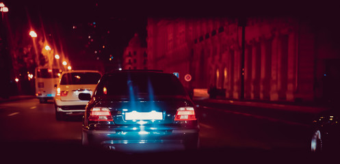 Night view of the cars. the road in the city at the night with yellow and red electrical light for cars during they are coming home. Rear view of the car at night . Back view of the car at night .