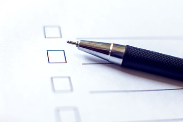 Checklist form with a pen on white paper. Checkbox concept.