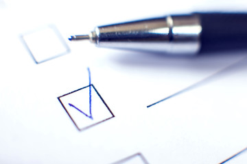 Checklist form with a pen on white paper. Checkbox concept.