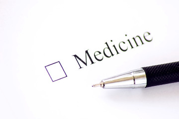 Medicine - checkbox with a cross on white paper with pen. Checklist concept.