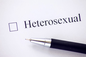 Checklist with a word Heterosexual on white paper. Checkbox concept.