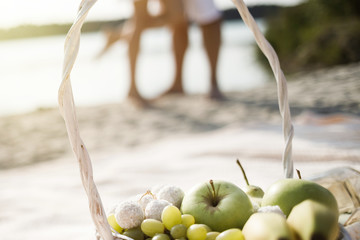 Young couple is holding hands at the beach on a sunny day.