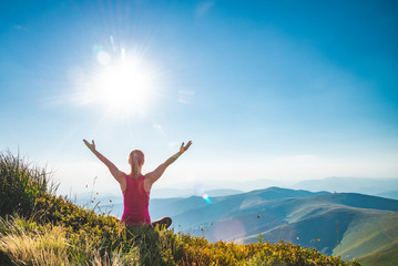 Young woman on the top of mountain