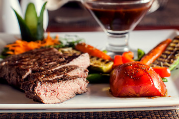 Beef steak with grilled vegetables served on white plate. Food concept
