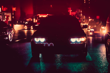 Night view of the cars. Road in the city at the night with yellow and red electrical light for cars during they are coming home. The cars compete at night. Only the lights of night carriages. - obrazy, fototapety, plakaty