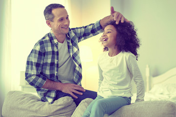 Young at heart dad plaing around with his funny kid.