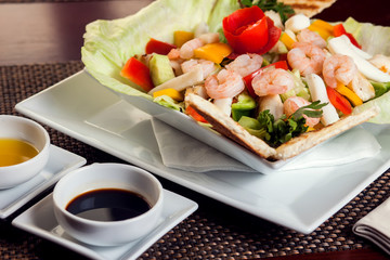 Sea food salad with sauces on white plate. Food and restaurant concept