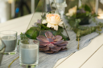 Florarium with fresh succulent and rose flowers festive table decoration. Event fresh flowers decoration. Florist workflow. Wedding ceremony  design