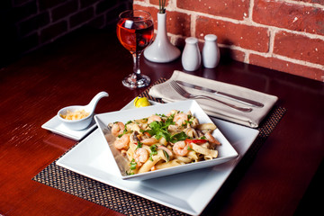 Penne (pasta) with shrimps/prawns and sausage in pomodoro (tomato) sauce - Italian cuisine, cooking, culinary (traditional authentic taste). Food and restaurant concept