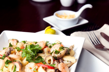 Penne (pasta) with shrimps/prawns and sausage in pomodoro (tomato) sauce - Italian cuisine, cooking, culinary (traditional authentic taste). Food and restaurant concept