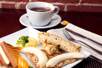 Healthy Full American Breakfast with Pancakes, Banana and toasts with butter. Food and restaurant concept