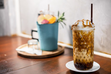 Ice latte with  Fruit juice flavor in sparking soda water and ice serve in the jar , selective focus on ice latte