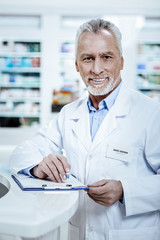 Handsome tall bearded gentleman in a white coat feeling wonderful