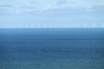 A Number of Turbines at an Offshore Coastal Wind Farm.