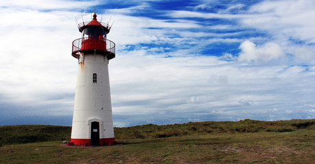 Beautiful traditional lighthous at the island sylt germany, guiding the ships through the night at the north sea