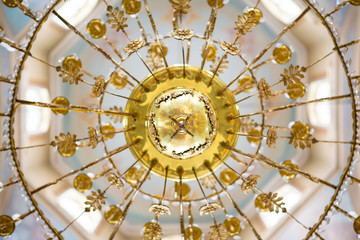 ceiling in the church with the illuminator. church lamp look from below