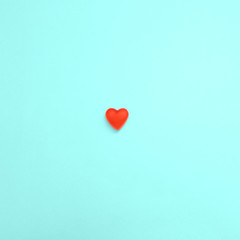 Valentine's day background Flat lay Sweet red heart-shaped candy on a turquoise background Template for posters and banners with copy space