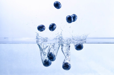 Blueberries Splashing into Water