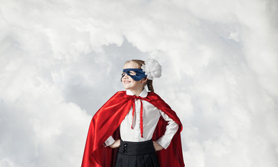 Girl power concept with cute kid guardian against sky background