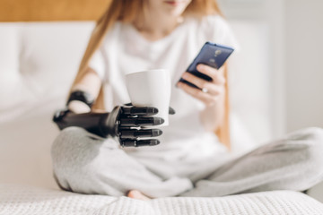 close up photo. cyber hand holding a cup, blured background. free time. lifestyle, spare time