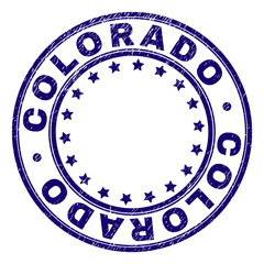 COLORADO stamp seal imprint with distress texture. Designed with round shapes and stars. Blue vector rubber print of COLORADO caption with retro texture.
