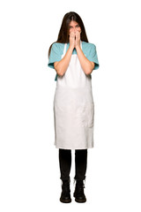 Full-length shot of Girl with apron smiling a lot while covering mouth on isolated white background