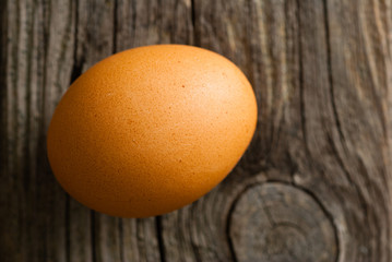 single egg on weathered wooden table