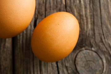 two eggs on weathered wooden table