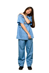 Fototapeta premium Full-length shot of Young nurse suffering from pain in shoulder for having made an effort on isolated white background