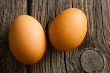 two eggs on weathered wooden table