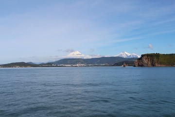 Avachinsky and Koryaksky volcanoes towers over the city of Petropavlovsk-Kamchatsky on the Kamchatka Peninsula, Russia.