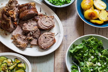 Easter meal with roast lamb, potatoes, courgette, garden peas and watercress salad