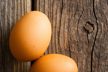 two eggs on weathered wooden table
