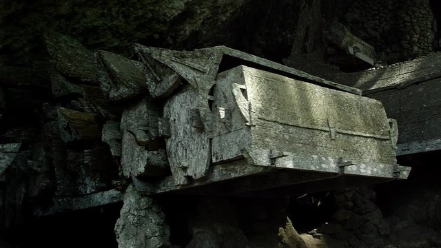 Toraja traditional burial ground. Coffins are situated in caves or hang on the cliff, Indonesia, May 2017