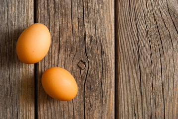 two eggs on weathered wooden table