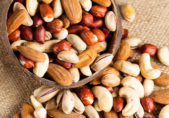 Healthy mix nuts on wooden background. Almonds, hazelnuts, cashews, peanuts, pistachios, brazilian nuts