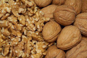 Walnuts with and without shells. Background of fresh walnuts.