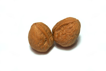 Whole two walnuts isolated on a white background.