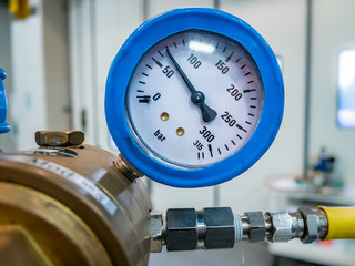 gas manometer on a valve, with yellow tube and metal fitting