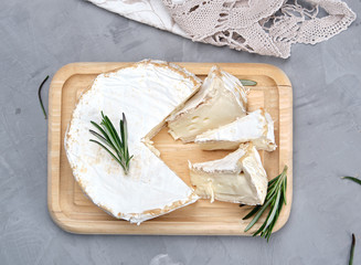 round brie cheese on a wooden board