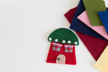 Playing with felt and making handmade house for children’s activities in preschool or nursery.creative handcraft and ideas for child development.back to school and happy teachers day concept.