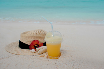Relax on a tropical island, concept. Protection from sun and heat. Straw hat and pineapple juice