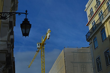 Fototapeta na wymiar Big yellow crane works in the city