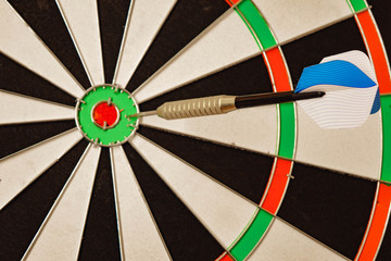 darts game one blue arrows on a red background.