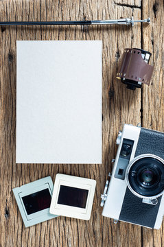 Antique photography concept with vintage camera film and blank paper for text or image