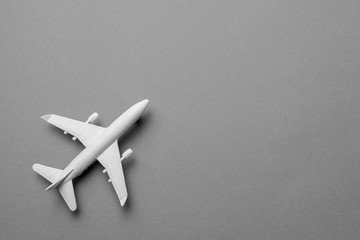 White passenger plane on gray background. Copy space for text.