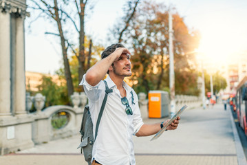 Lost tourist looking at city map on a trip. Looking for directions.