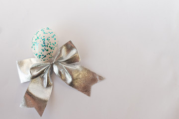 Easter background with Easter blue egg with bow.